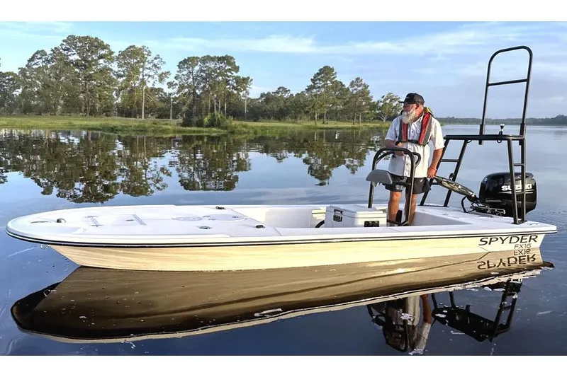 The Image of Manufacturer Provided Image: 2025 Spyder FX16 Wisp boat on calm lake with trees in background. - 0