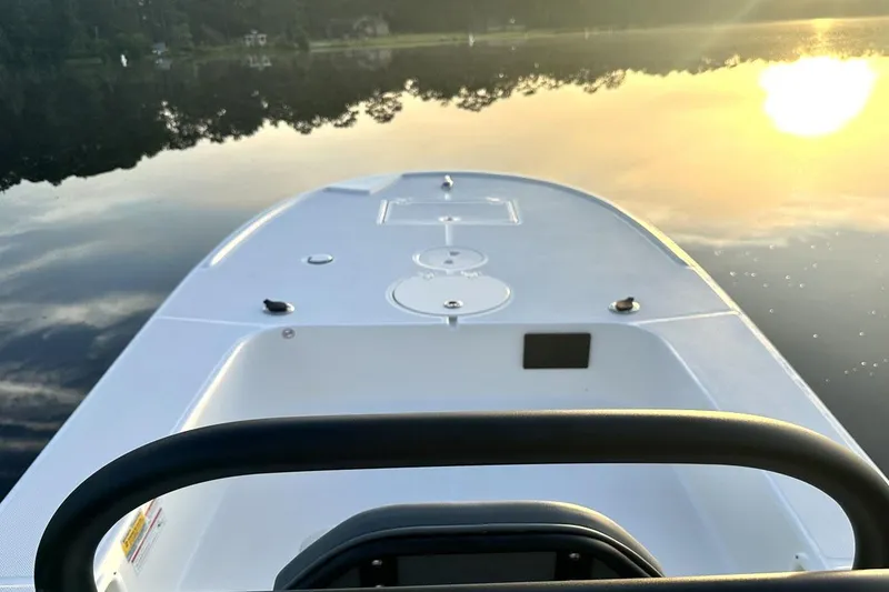 Slide: The Image of Manufacturer Provided Image: 2025 Spyder FX16 Wisp boat on calm water at sunrise. - 3