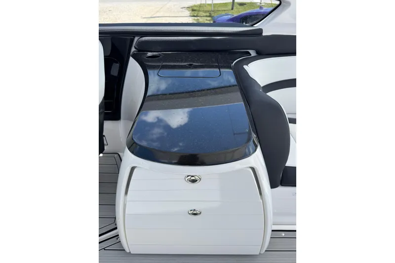 Slide: The Image of 2026 Yamaha Boats 275SD interior with sleek black countertop and white cabinetry. - 12