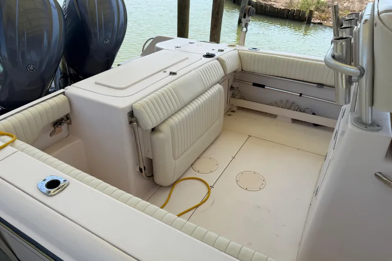 Slide: The Image of 2004 Grady-White Advance 257 boat interior with seating and dual outboard motors. - 13