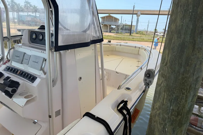 Slide: The Image of 2004 Grady-White Advance 257 boat docked, featuring a well-equipped control panel. - 14