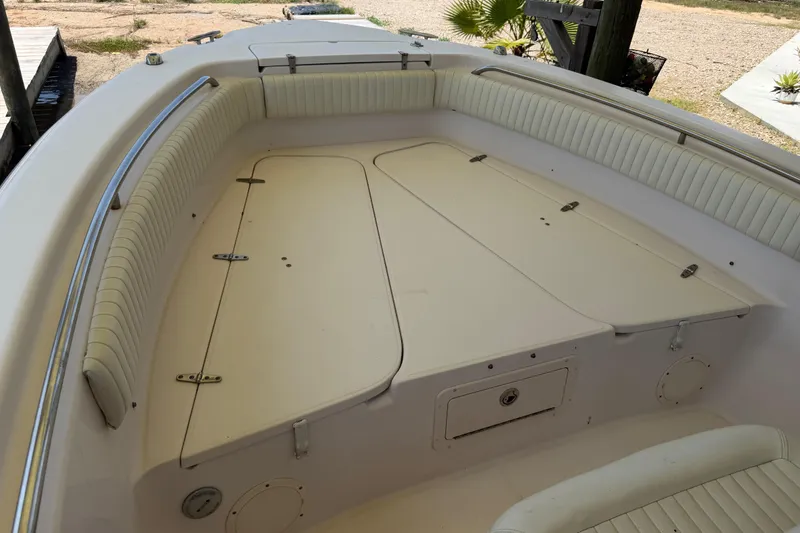 Slide: The Image of 2004 Grady-White Advance 257 boat interior with cushioned seating and storage compartments. - 21