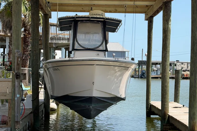 Slide: The Image of 2004 Grady-White Advance 257 boat suspended in a dockside lift. - 30