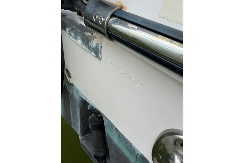 Slide: The Image of Close-up of 2004 Grady-White Advance 257 boat hull with visible serial number. - 34