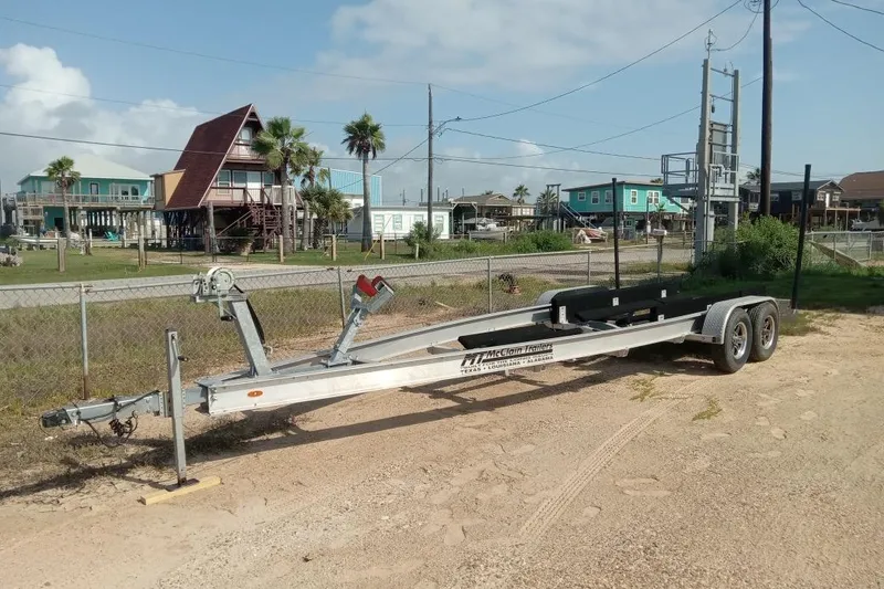 Slide: The Image of Boat trailer for 2004 Grady-White Advance 257, parked near coastal homes. - 35