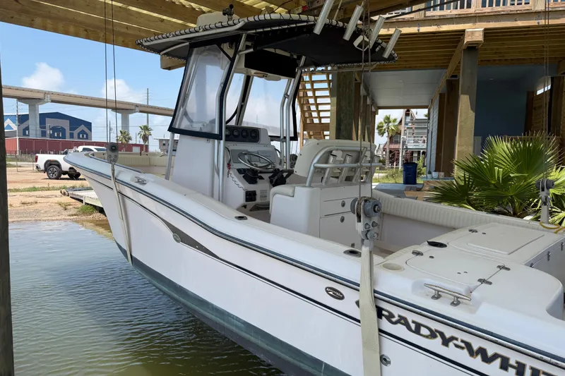 Slide: The Image of 2004 Grady-White Advance 257 boat docked under a wooden structure. - 4