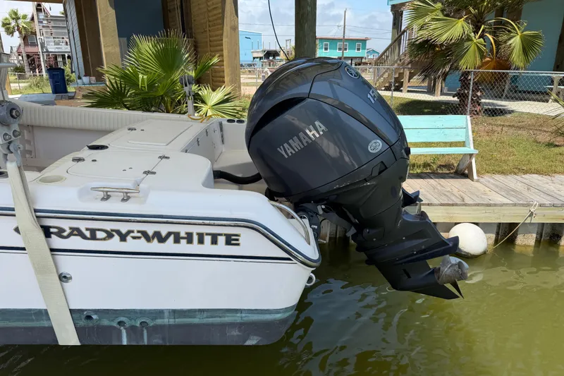 Slide: The Image of 2004 Grady-White Advance 257 boat with Yamaha outboard motor docked by palm trees. - 5
