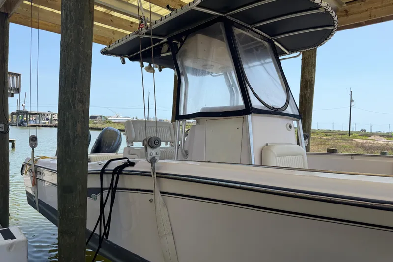 Slide: The Image of 2004 Grady-White Advance 257 boat docked under a wooden shelter. - 6