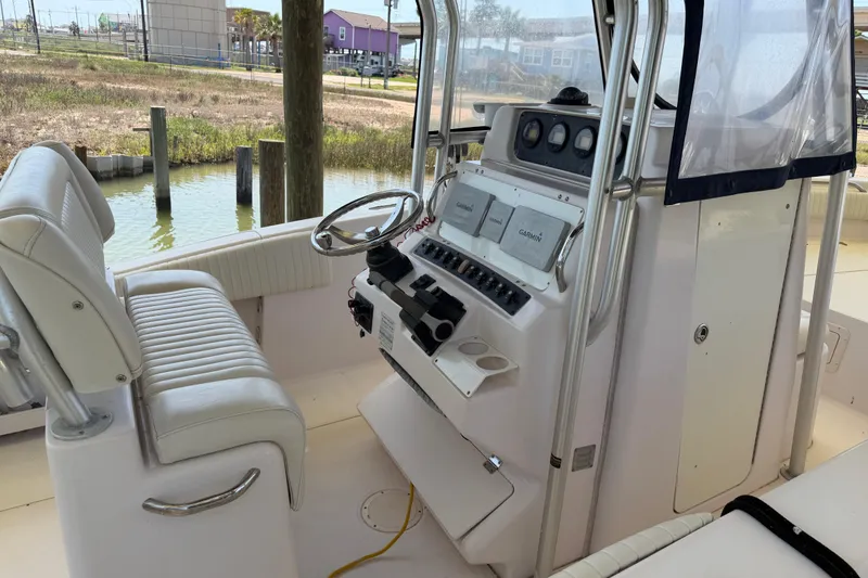 Slide: The Image of 2004 Grady-White Advance 257 boat interior with steering console and seating. - 9