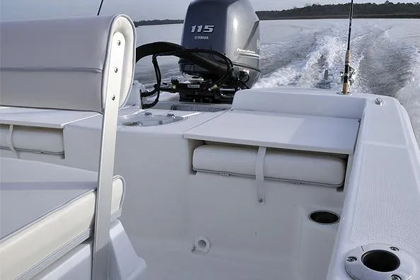 Slide: The Image of Manufacturer Provided Image: 2025 Sundance DX20 boat interior with Yamaha 115 engine, featuring seating and fishing rod holders. - 12