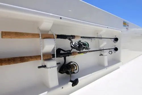 Slide: The Image of Manufacturer Provided Image: Fishing rods stored in a Sundance DX20 boat, model year 2025, against a clear blue sky. - 14