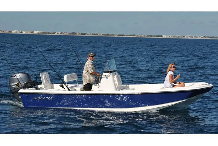 Slide: The Image of Manufacturer Provided Image: 2025 Sundance DX20 boat cruising on open water with two passengers. - 2