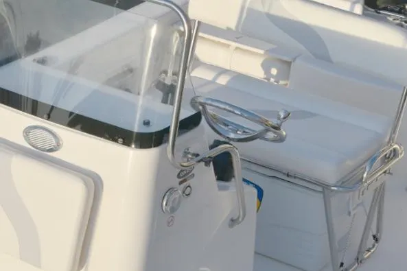Slide: The Image of Manufacturer Provided Image: 2025 Sundance DX20 boat interior with steering wheel and seating area. - 9