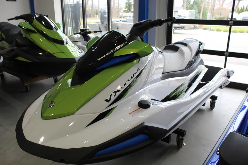 The Image of 2026 Yamaha WaveRunner VX Deluxe in showroom, featuring sleek green and white design. - 0