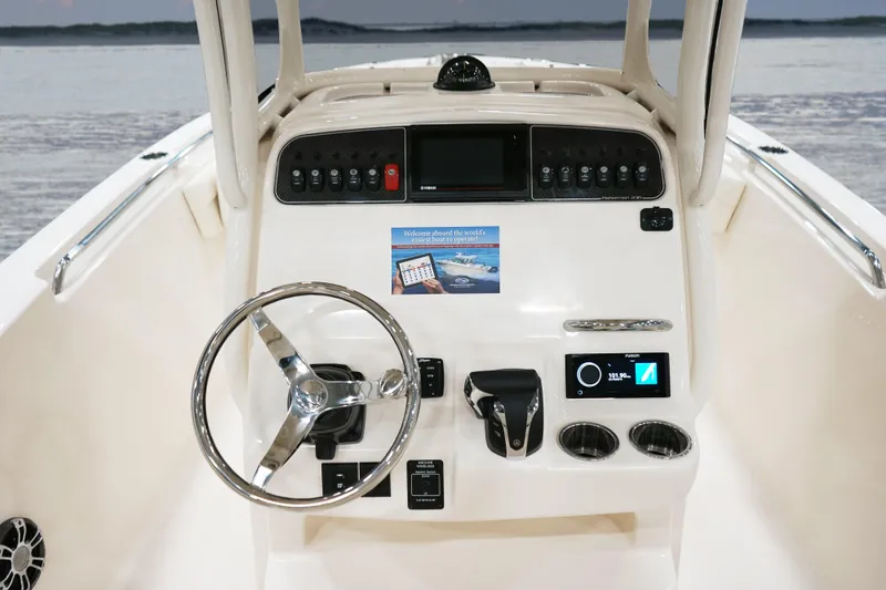 Slide: The Image of 2026 Grady-White Fisherman 236 boat dashboard with steering wheel and controls. - 8