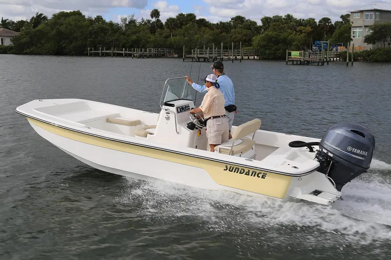 The Image of Manufacturer Provided Image: 2025 Sundance B22CCR boat cruising on a calm river with two passengers. - 0