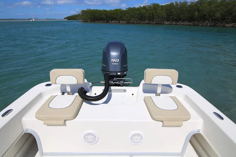 Slide: The Image of Manufacturer Provided Image: 2025 Sundance B22CCR boat with 90 HP engine on calm blue water. - 8
