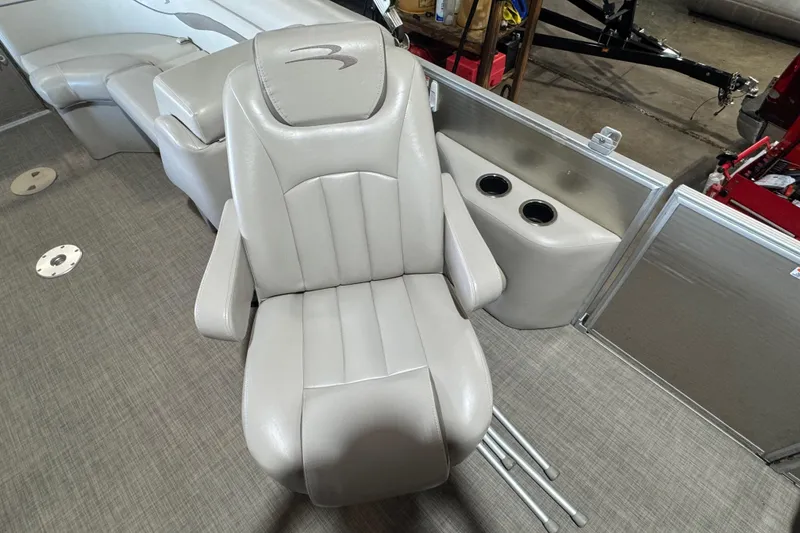 Slide: The Image of 2016 Bennington 20 SSRX boat interior with plush captain's chair and cup holders. - 10