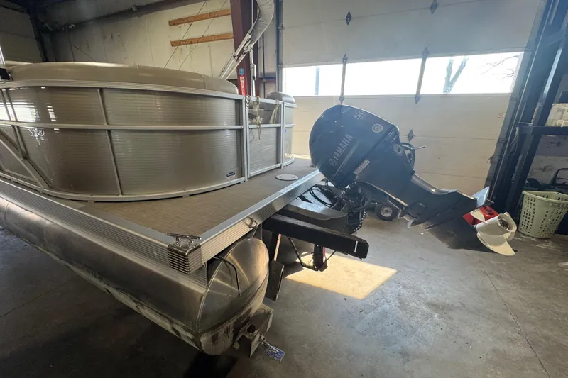 Slide: The Image of 2016 Bennington 20 SSRX pontoon boat with Yamaha outboard motor in a garage. - 12