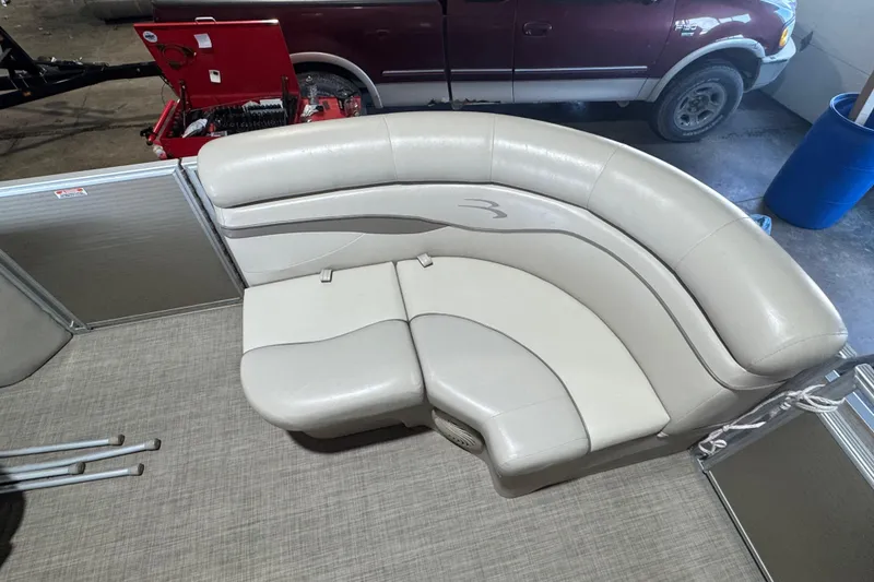 Slide: The Image of 2016 Bennington 20 SSRX pontoon boat with beige seating and carpeted flooring. - 3