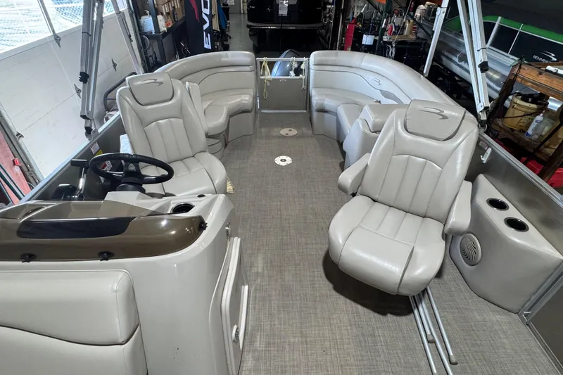 Slide: The Image of 2016 Bennington 20 SSRX pontoon boat interior with plush seating and steering console. - 4