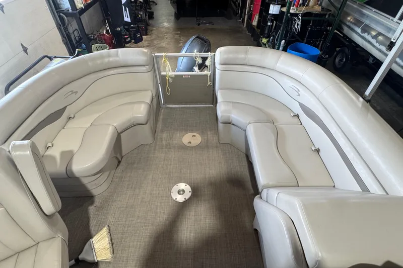 Slide: The Image of 2016 Bennington 20 SSRX pontoon boat interior with beige seating and clean flooring. - 6