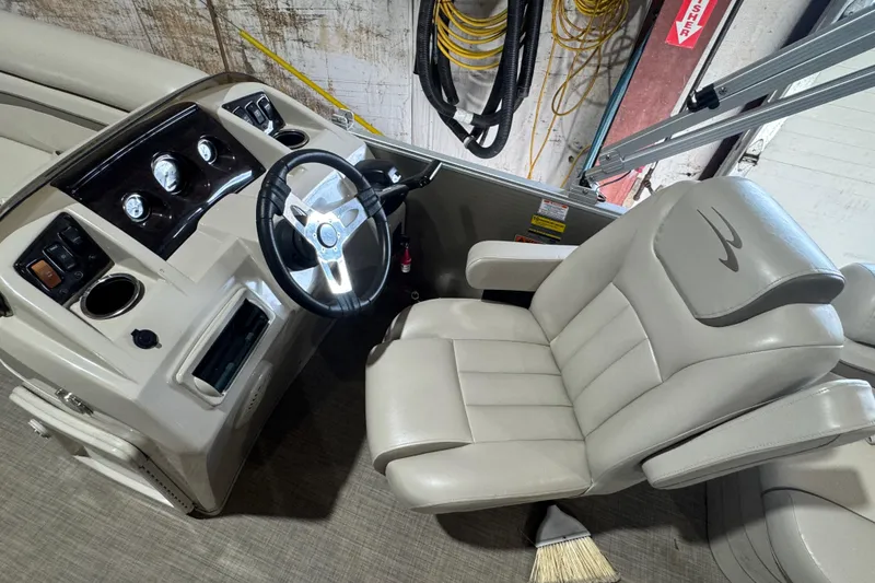 Slide: The Image of 2016 Bennington 20 SSRX boat interior with steering wheel and captain's chair. - 7