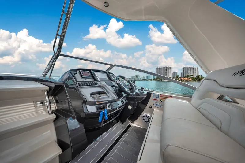 Slide: The Image of 2014 Monterey 320 Sport Yacht interior with modern dashboard and waterfront view. - 21
