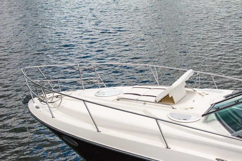 Slide: The Image of 2014 Monterey 320 Sport Yacht on calm water, showcasing sleek deck design. - 8
