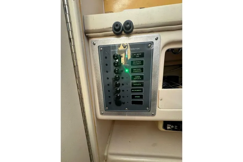 Slide: The Image of Control panel on a 2001 Grady-White Express 265 boat, showing electrical switches. - 10