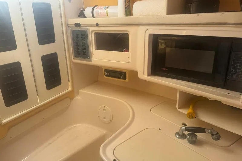 Slide: The Image of 2001 Grady-White Express 265 boat interior with microwave and control panel. - 11