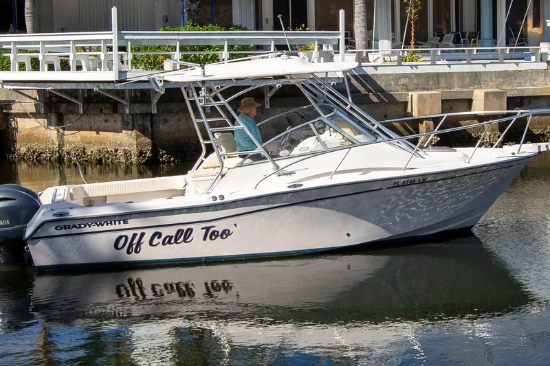 Slide: The Image of 2001 Grady-White Express 265 boat docked on calm water. - 3