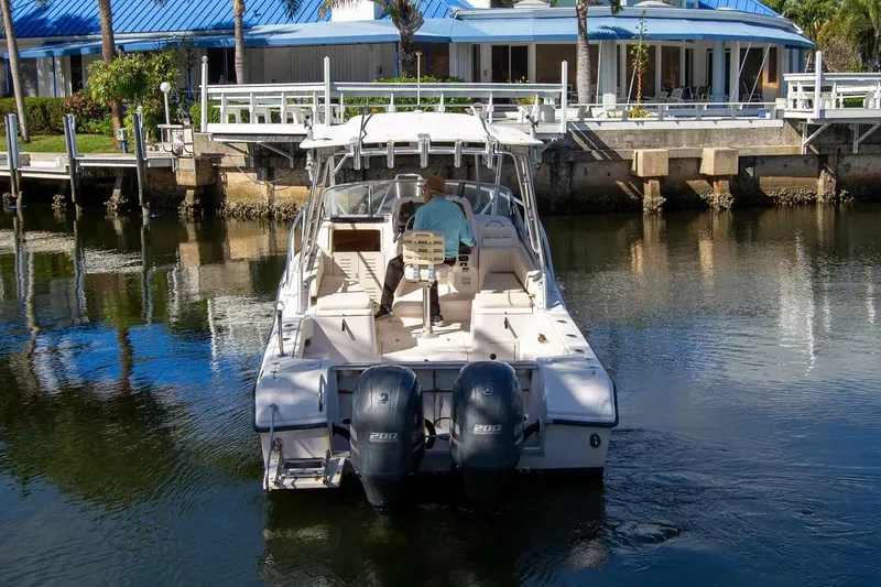 Slide: The Image of 2001 Grady-White Express 265 boat docked near waterfront property. - 4