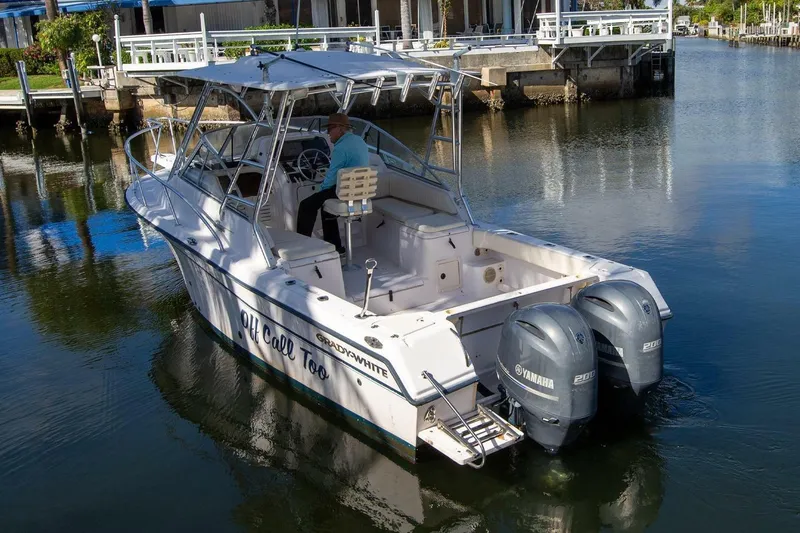 Slide: The Image of 2001 Grady-White Express 265 boat with dual Yamaha engines on a calm waterway. - 5