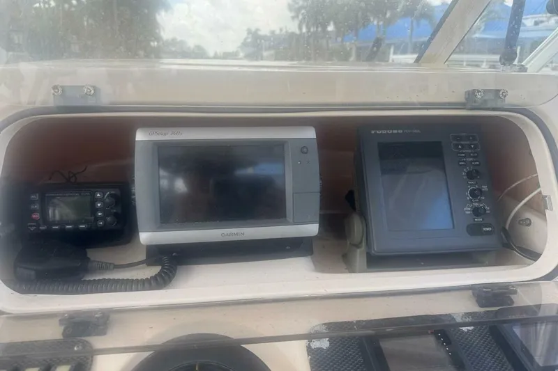 Slide: The Image of 2001 Grady-White Express 265 boat dashboard with Garmin and Furuno navigation systems. - 6