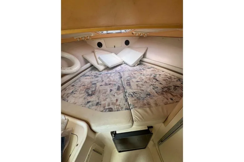 Slide: The Image of 2001 Grady-White Express 265 cabin interior with patterned cushions and compact layout. - 7