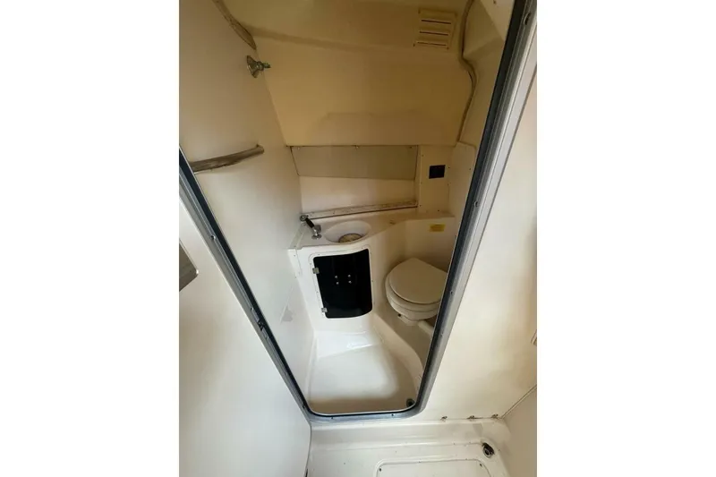 Slide: The Image of 2001 Grady-White Express 265 boat bathroom interior with toilet and sink. - 9