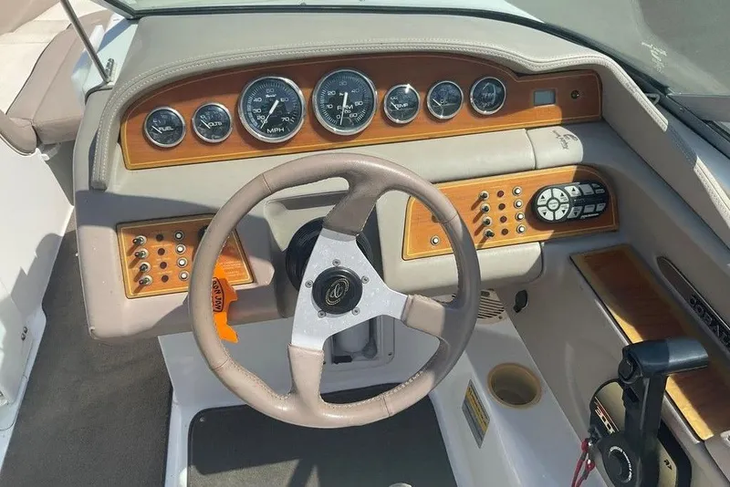 Slide: The Image of Steering console of a 2000 Cobalt 226 boat with gauges and controls. - 10