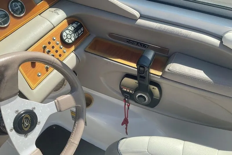 Slide: The Image of Interior of a 2000 Cobalt 226 boat showing steering wheel and control panel. - 13