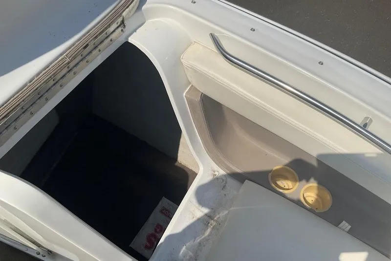 Slide: The Image of Interior of a 2000 Cobalt 226 boat showing seating and storage area. - 16