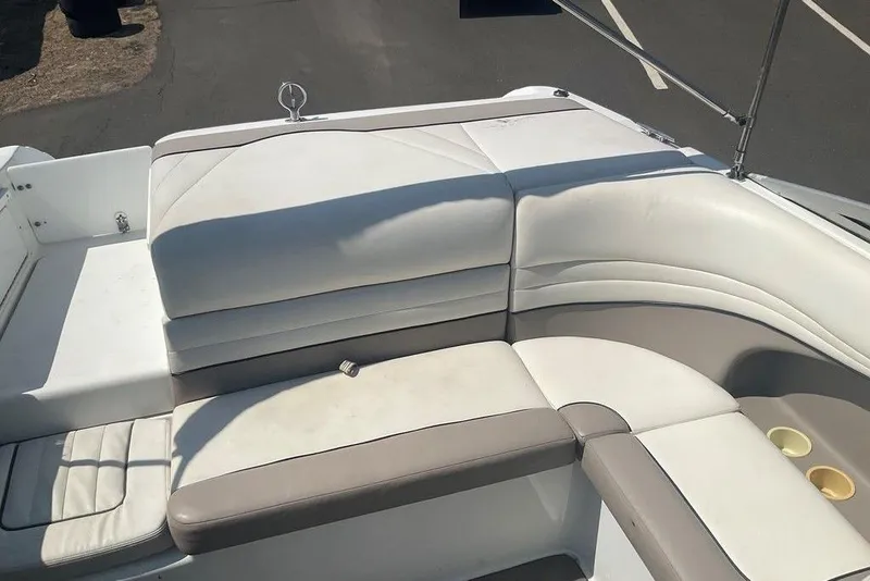 Slide: The Image of Cobalt 226 boat interior, 2000 model, featuring white and beige cushioned seating. - 18