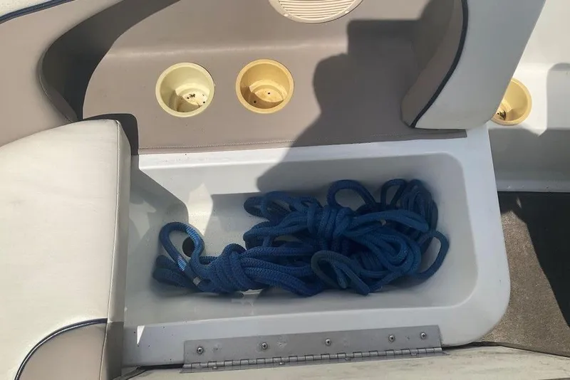 Slide: The Image of Storage compartment with blue rope on a 2000 Cobalt 226 boat. - 20