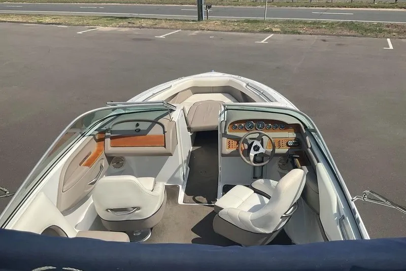 Slide: The Image of Interior view of a 2000 Cobalt 226 boat, featuring seating and dashboard controls. - 4