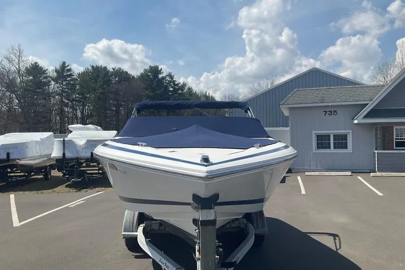 Slide: The Image of 2000 Cobalt 226 boat on trailer in parking lot, clear sky background. - 6