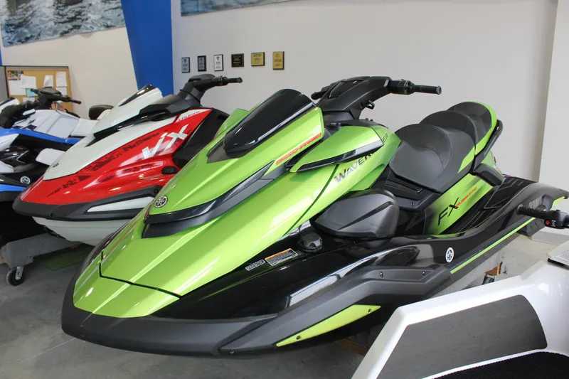 The Image of 2024 Yamaha WaveRunner FX Cruiser SVHO in vibrant green, displayed indoors. - 0