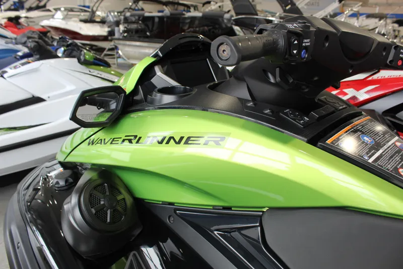 Slide: The Image of 2024 Yamaha WaveRunner FX Cruiser SVHO in vibrant green, displayed in a showroom. - 2