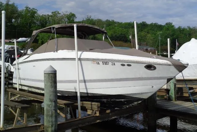 The Image of 2006 Cobalt 282 boat docked at a marina with protective cover. - 0