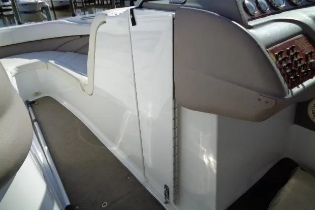 Slide: The Image of 2006 Cobalt 282 boat interior with white seating and control panel. - 10