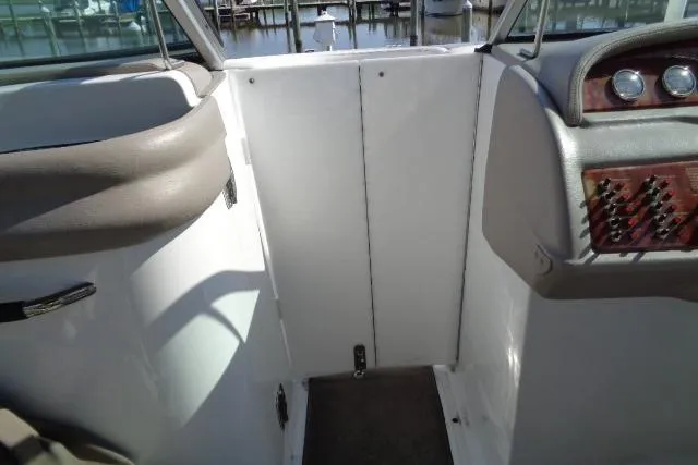 Slide: The Image of 2006 Cobalt 282 boat interior with dashboard and seating, docked at marina. - 11