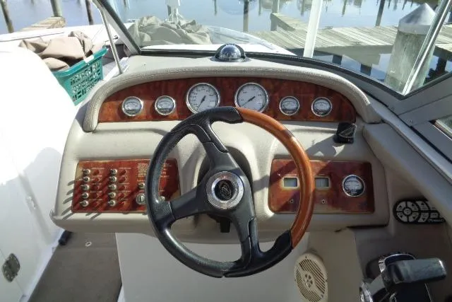 Slide: The Image of 2006 Cobalt 282 boat dashboard with steering wheel and instrument panel. - 12
